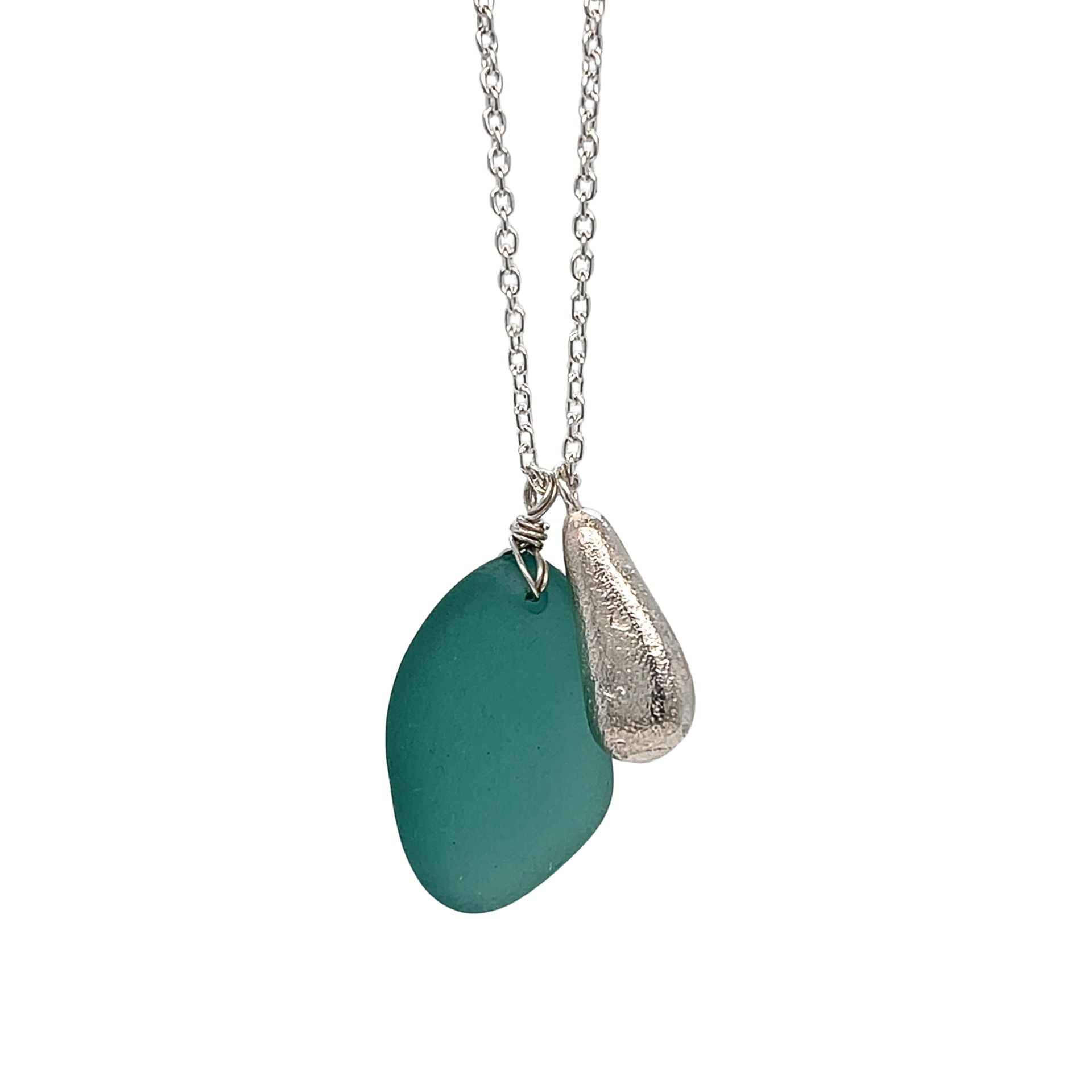 Long silver necklace with large teal sea glass and silver charm pendant