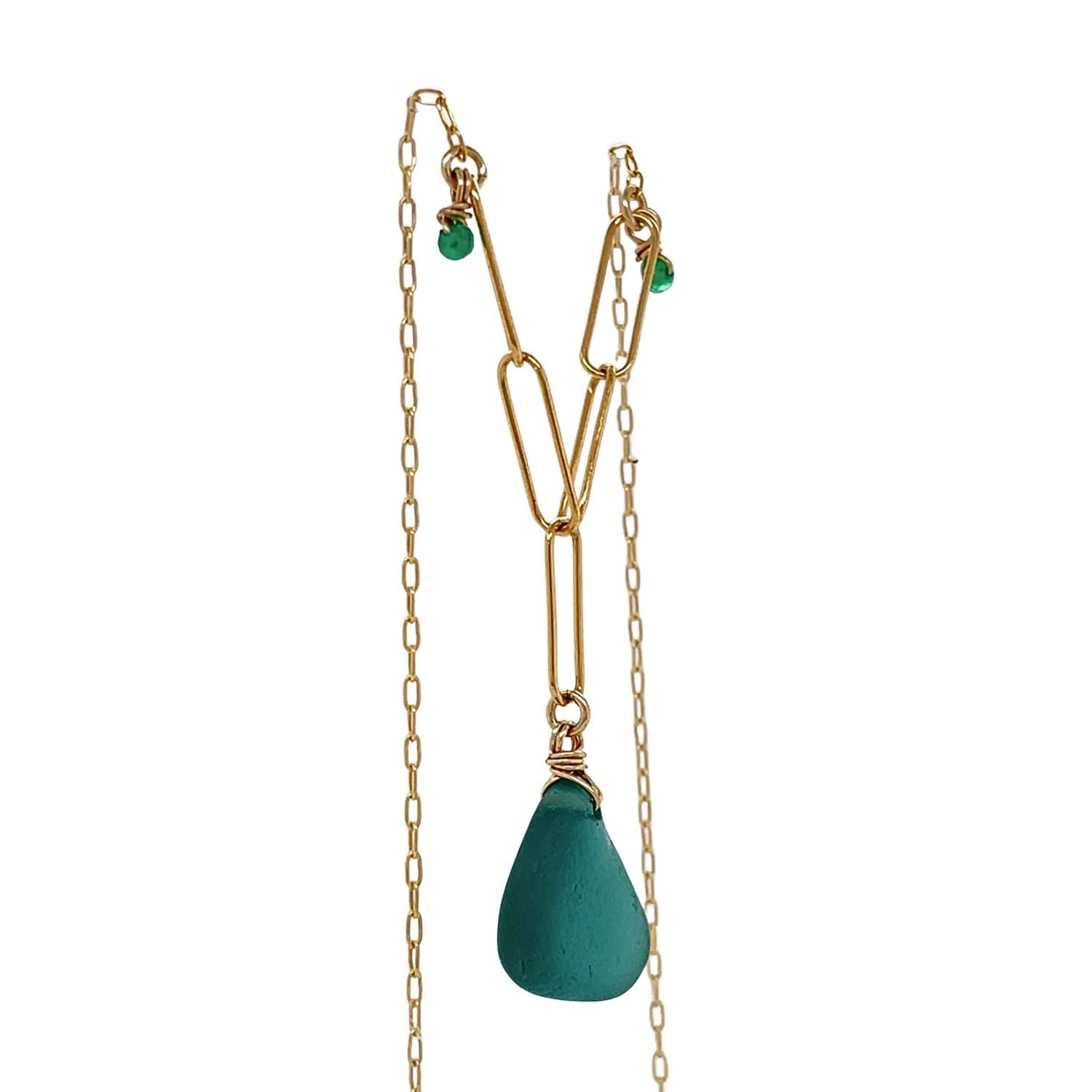 Handcrafted teal sea glass and gold necklace on white background