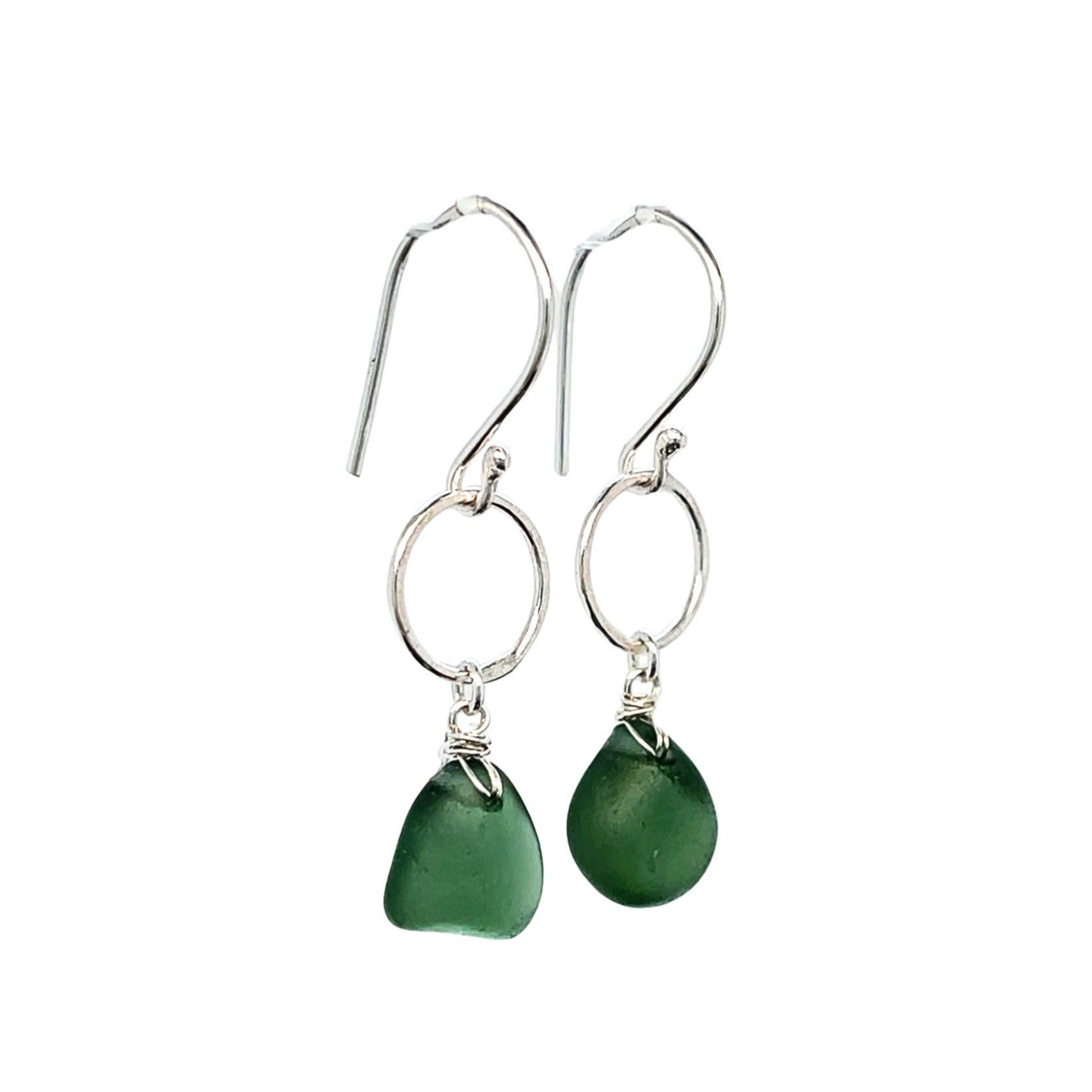 Close-up of green sea glass drops on sterling silver circles