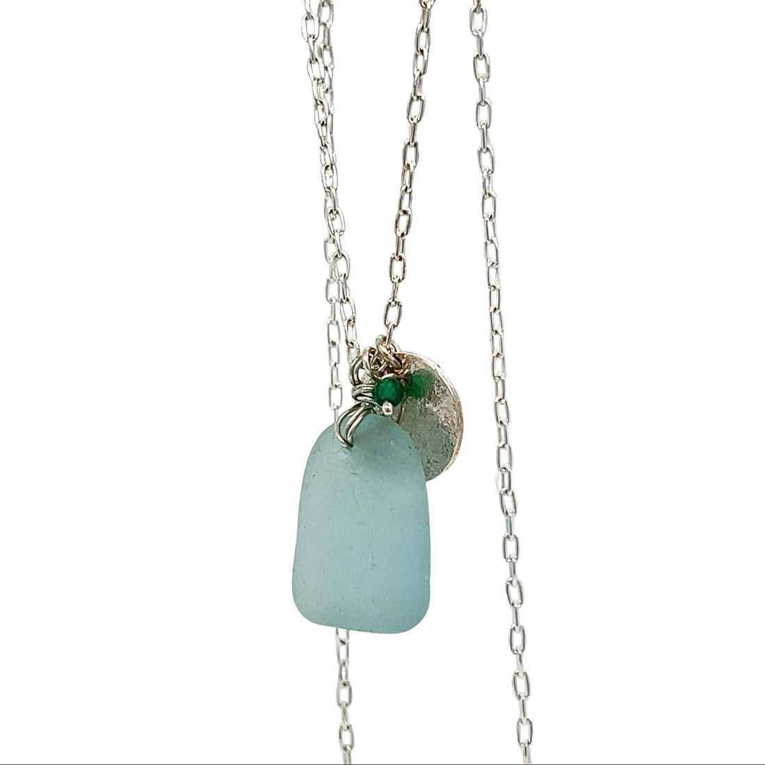 Close-up of aqua sea glass pendant and silver chain