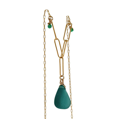Handcrafted teal sea glass and gold necklace on white background