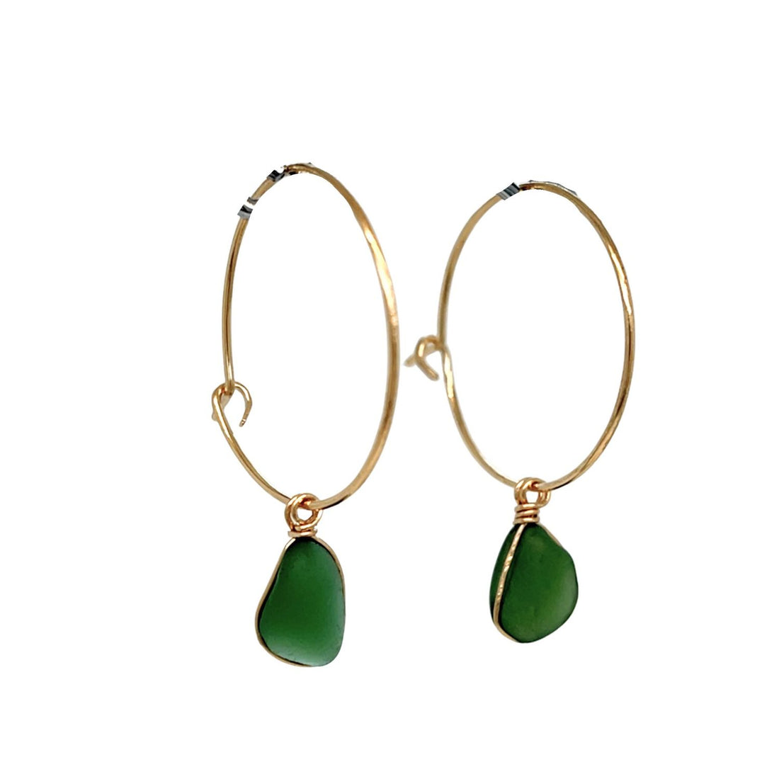 Close-up of green sea glass drop on gold hoops