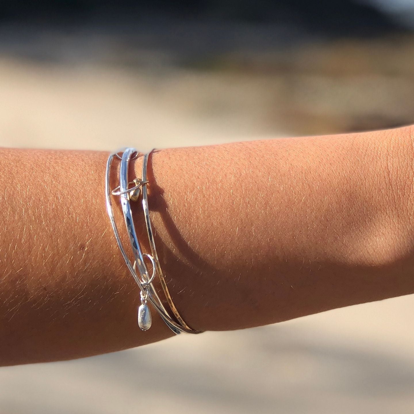 Handcrafted silver bangle with organic sea glass pendant
