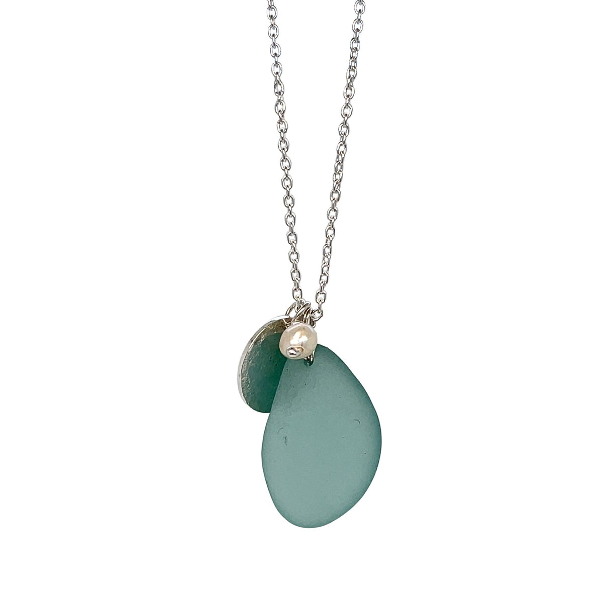 Close-up of pearl drop and matte silver disc detail
