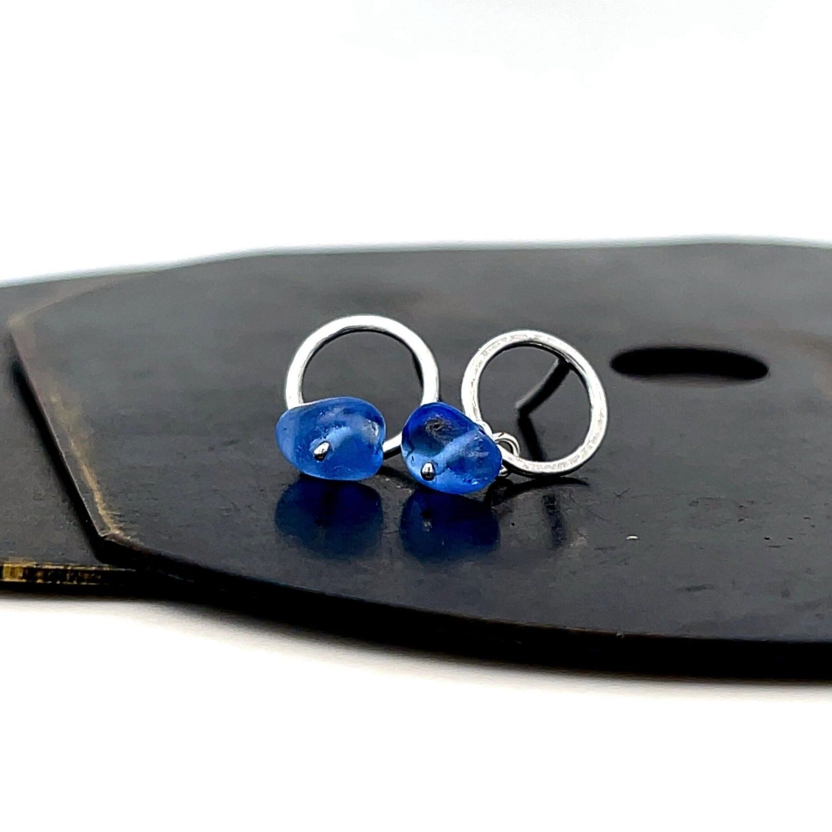 Handcrafted small silver stud earrings with blue sea glass detail