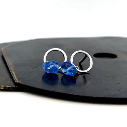 Handcrafted small silver stud earrings with blue sea glass detail