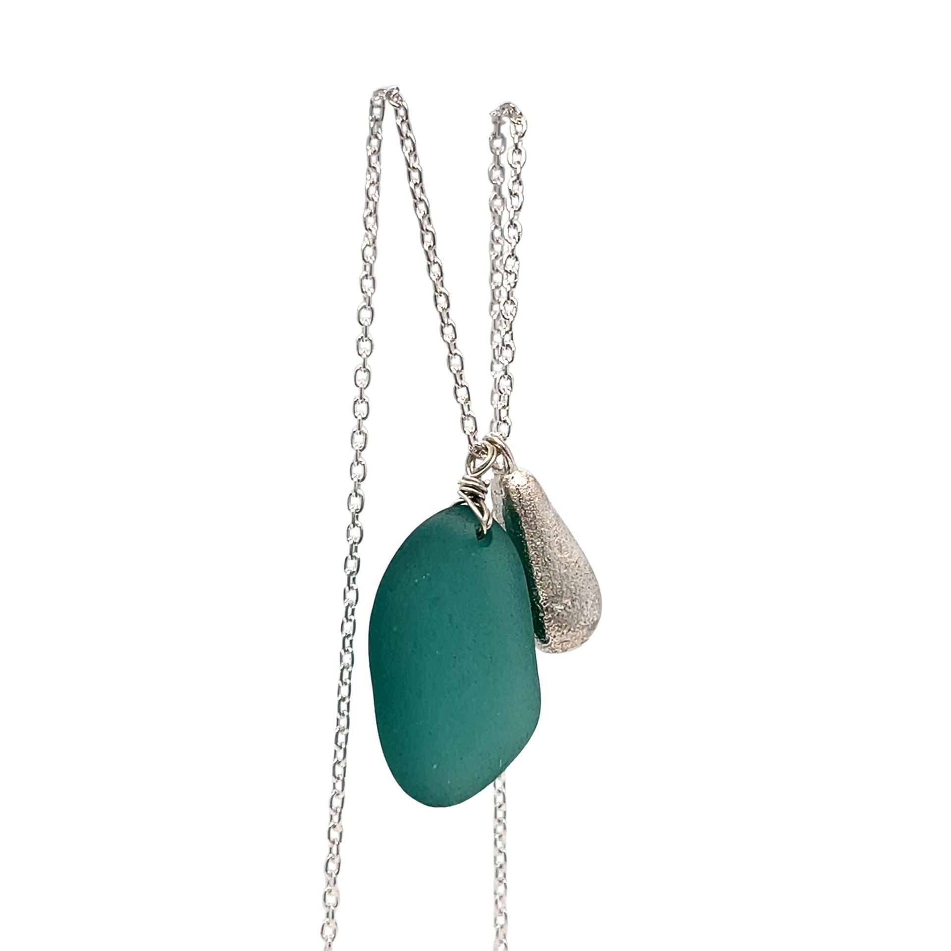 teal sea glass pendant with sculpted silver charm