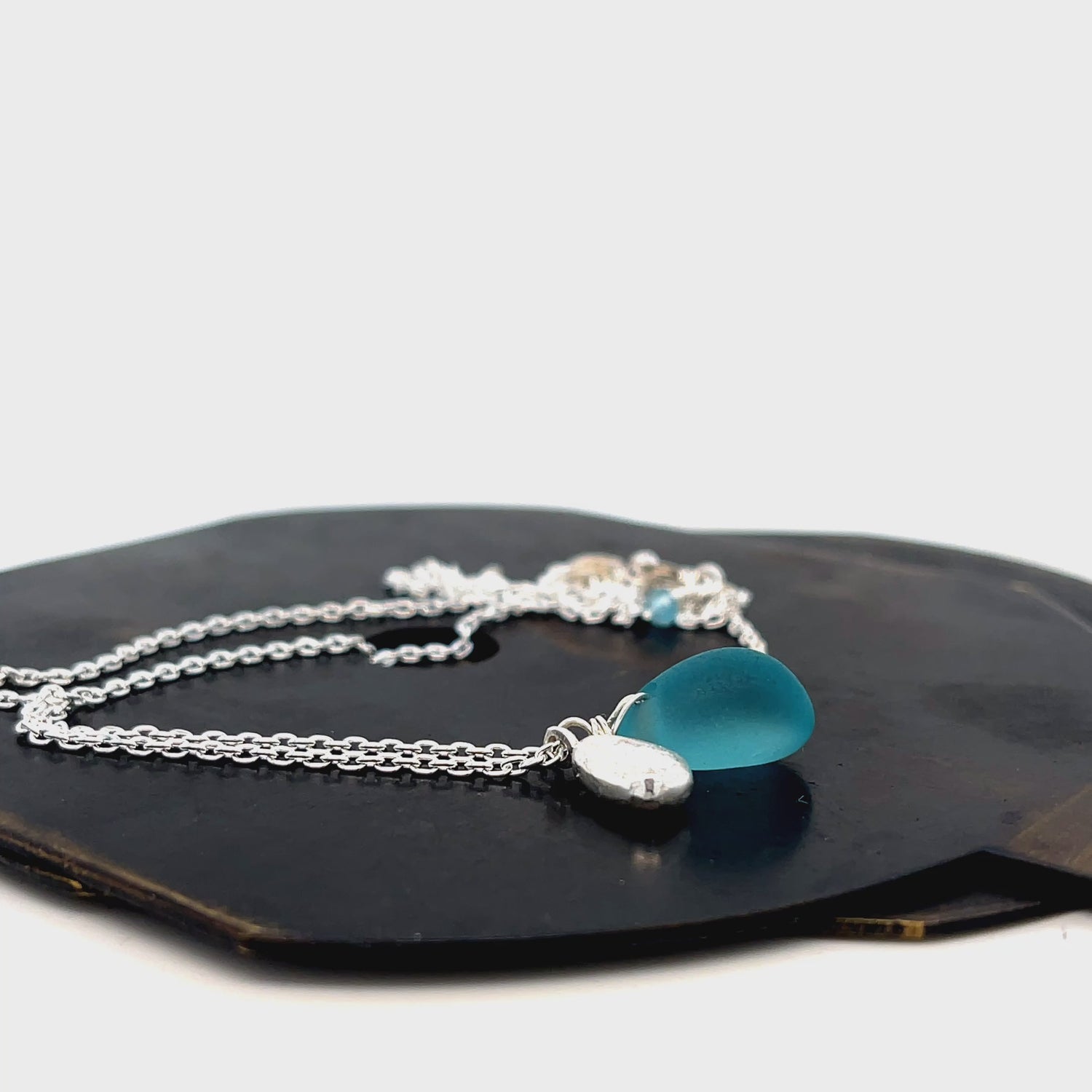 Turquoise sea glass and silver charm necklace by Kriket Broadhurst