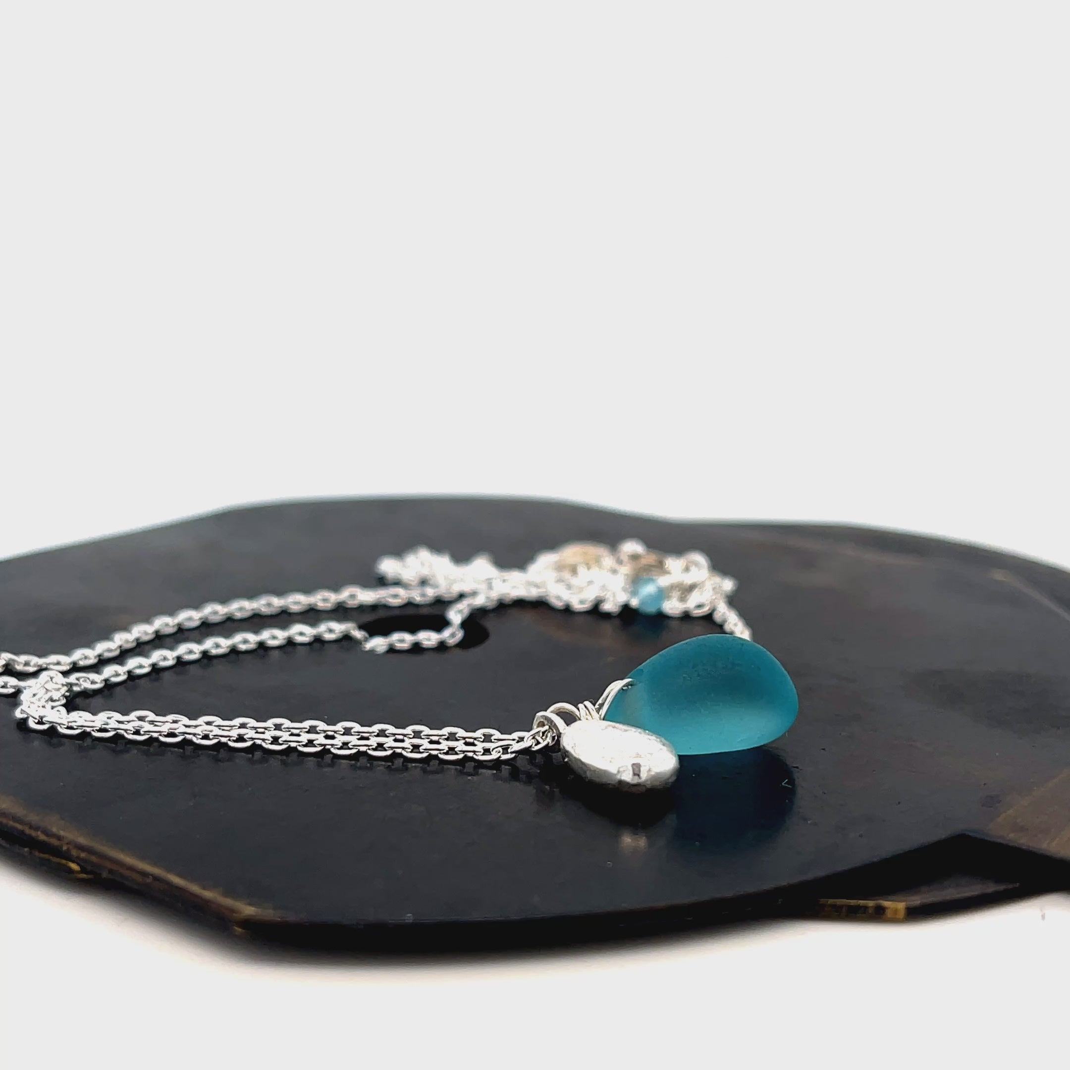 Turquoise sea glass and silver charm necklace by Kriket Broadhurst