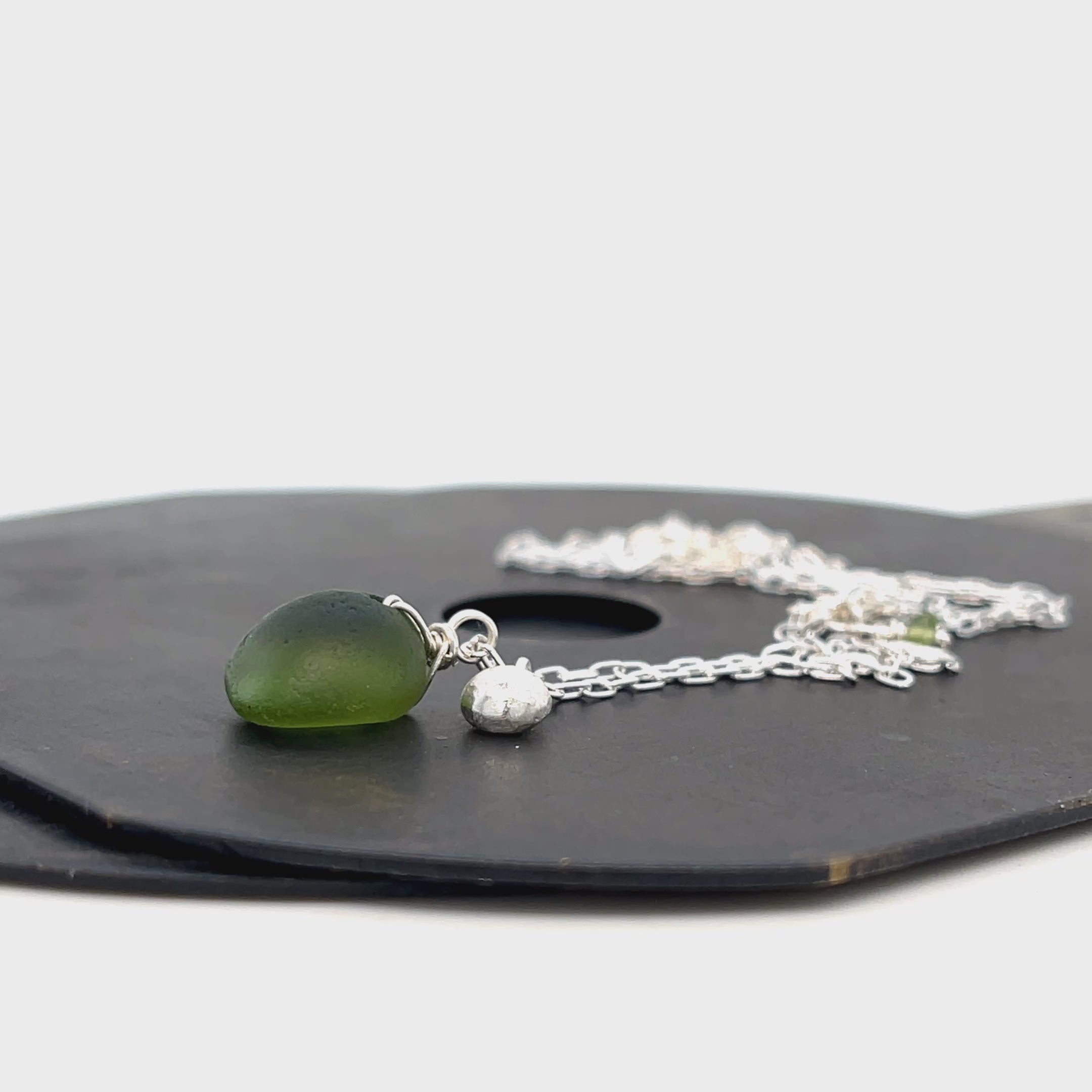 Handcrafted sterling silver sea glass necklace on white background