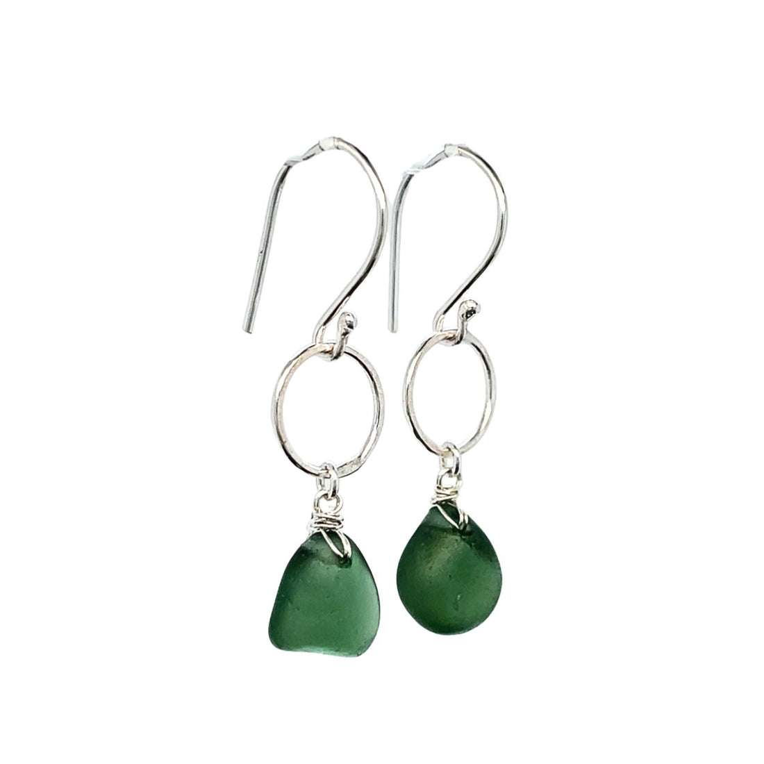 Close-up of green sea glass drops on sterling silver circles
