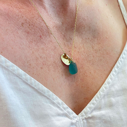 Handcrafted teal sea glass necklace on white background