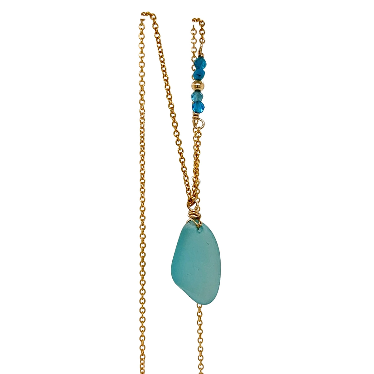 Close up of turquoise sea glass and gold wire wrap detail
