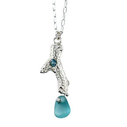Unique sea glass charm necklace with aqua blue nugget and granulated silver bail. Sustainable elegance in every detail